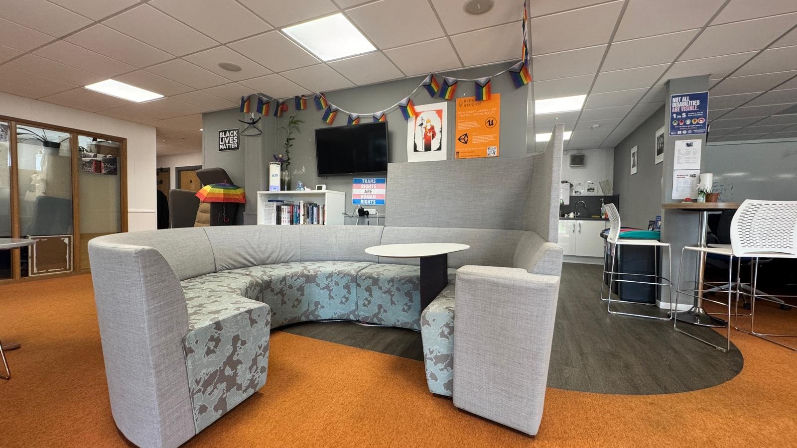 Meeting space with a large presentation screen at True SEO
